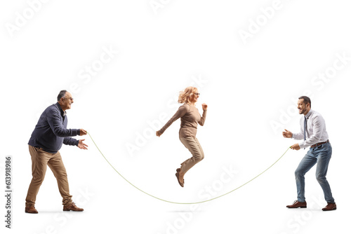 Full length shot of a woman with two men playing skipping rope