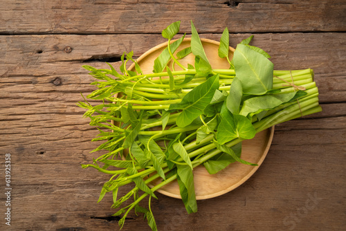 Thai Water Convolvulus,Pile of Water Spinach or Ipomoea Aquatica in wooden table photo