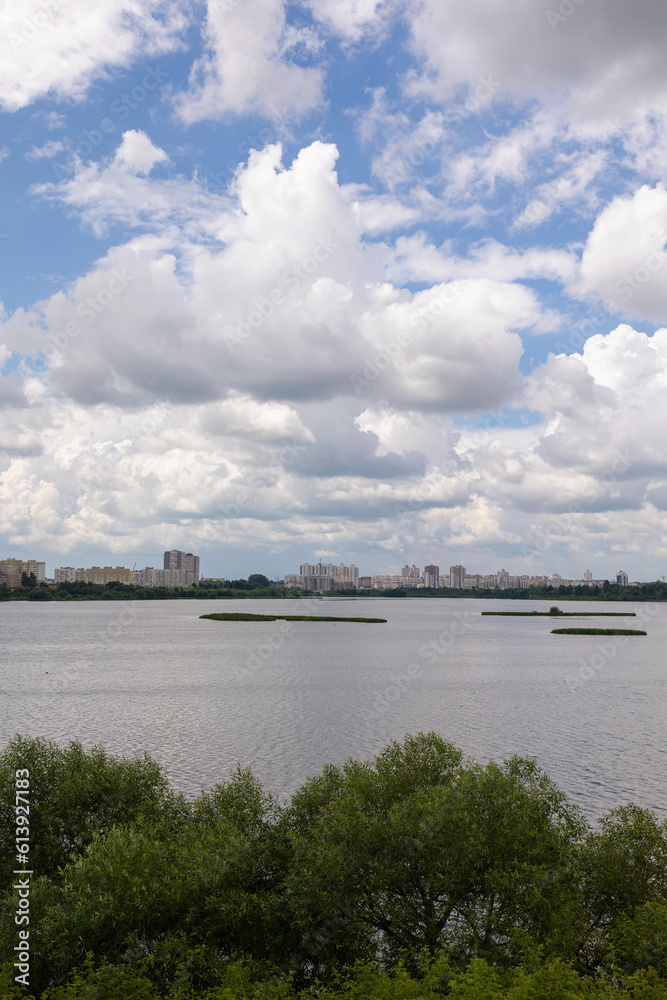 Landscape, view of the lake and the shore, green trees and water surface