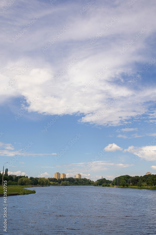Landscape, view of the lake and the shore, green trees and water surface Landscape, view of the lake and the shore, green trees and water surface