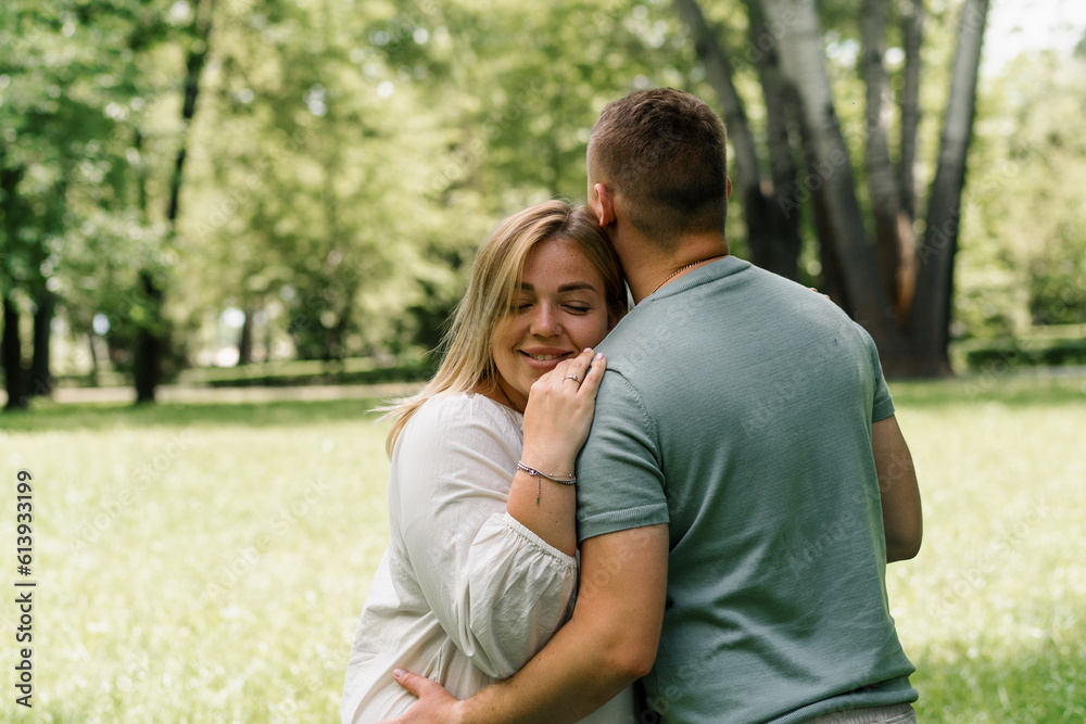 Obraz premium portrait of a couple in love a man and a pregnant woman are hugging, waiting for a new addition to the happy family