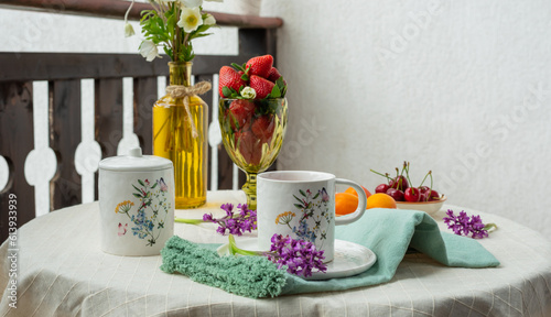 Morning tea with flowers and fruits on the terrace of a country house.