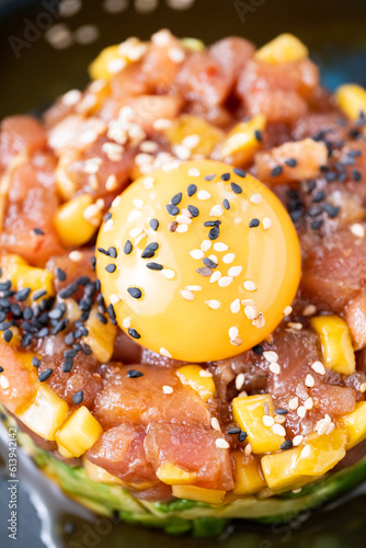 A detail of egg in a steak tartar with sesame seeds