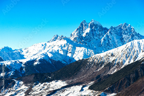 Beautiful sceneric view of Caucasus mountain. The way to mountain with pine forest covered with snow in winter season at Mestia Georgia