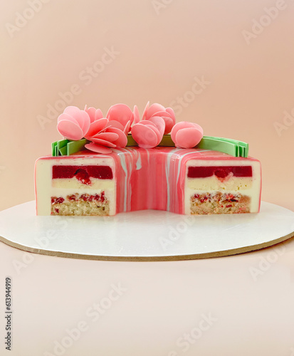 mousse cake dessert on a plate, cut in halves. festive cake with berry filling and mousse