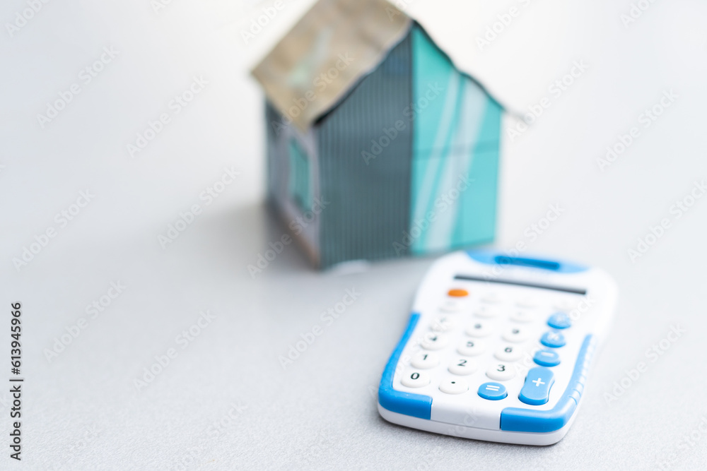 Real Estate Concept - Miniature Model House with Calculator Real Estate Concept - Miniature Model House with Calculator