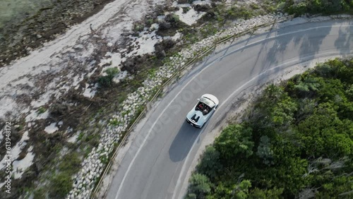 Aerial video view of sports car driving along the coast