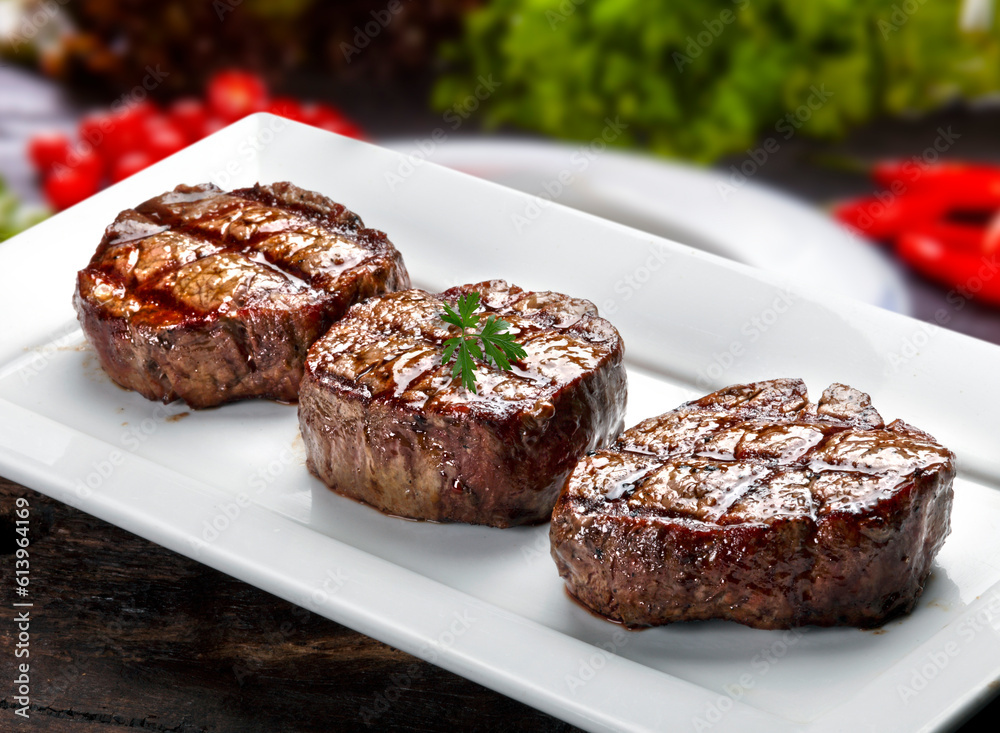 Three steaks roasted on the grill Three steaks roasted on the grill