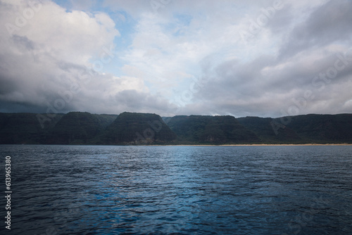 Fog over the mountains of the NaPali Coastline on the island of Kauai, Hawaii on a cloudy day from a sunsets boat cruise