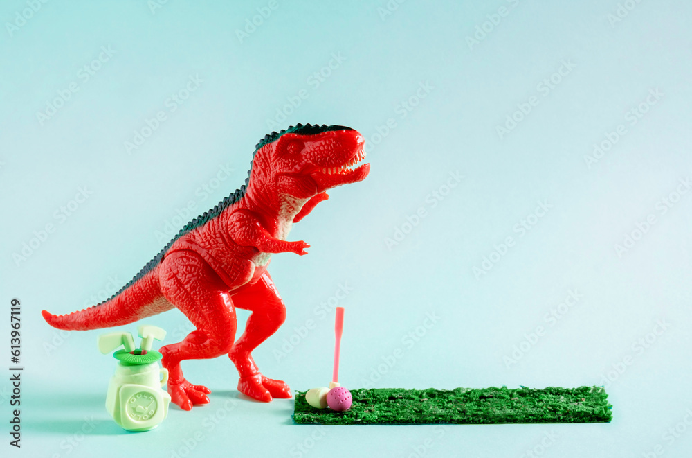 Cute red toy dinosaur playing mini golf on blue background. - obrazy, fototapety, plakaty 
