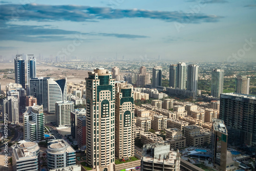 Panoramic aerial view of Dubai modern skyscrapers sunny summer day, urban background. Cityscape district UAE housing new city towers. Construction and modern architecture concept. Copy ad text space