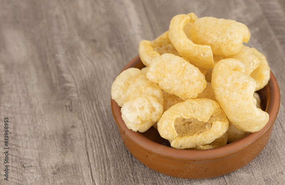 Tasty Snacks - Crispy Pork Cracklings; Dehydrated Pigskin. Delicious pile of fried pork cracklings or chicharron. Typical Mexican snack. Torreznos, fried pork rinds, typical spanish snack.