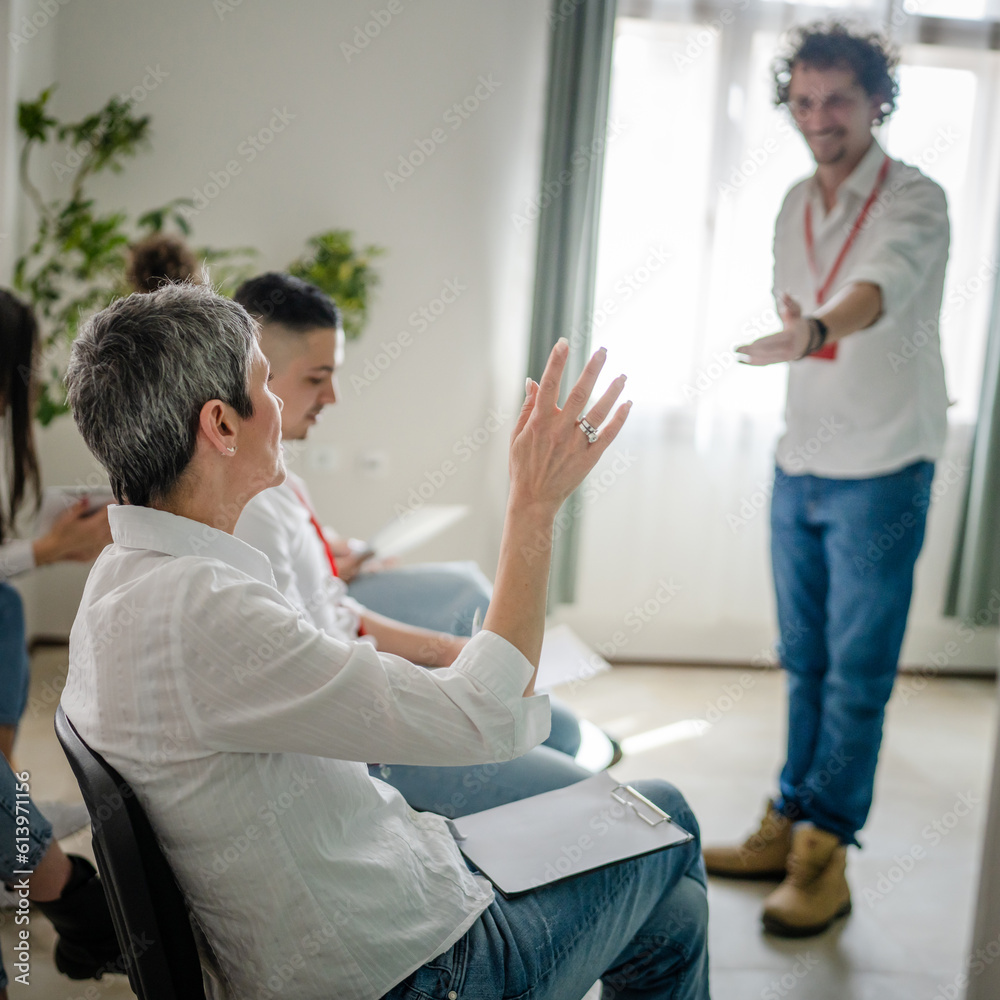 coach training speak explain question to group of employees at seminar coach training speak explain question to group of employees at seminar