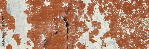 Peeling paint on the wall. Panorama of a concrete wall with old cracked flaking paint. Weathered rough painted surface with patterns of cracks and peeling. Wide panoramic texture for design background © Andrei Stepanov