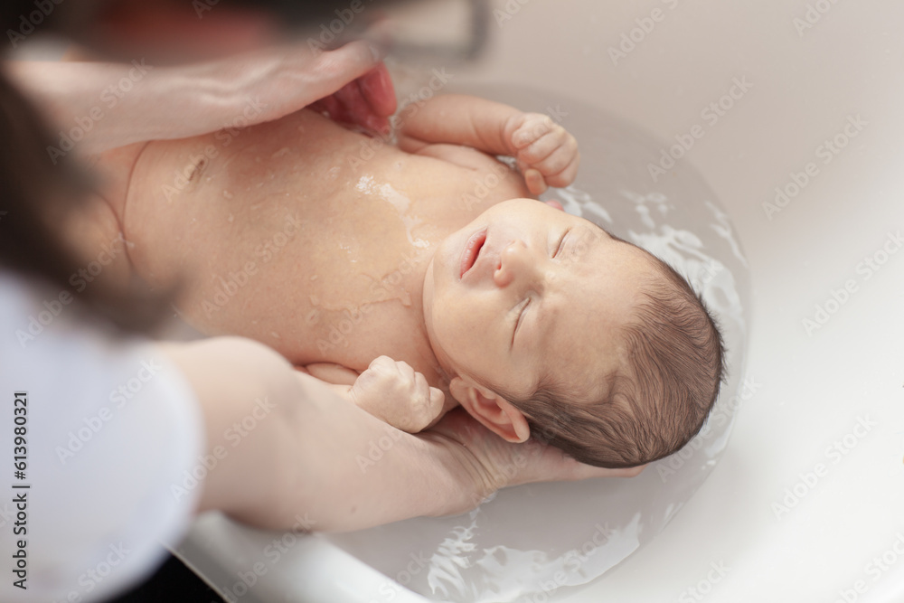 Cute newborn baby during care procedures. Cute newborn baby during care procedures.