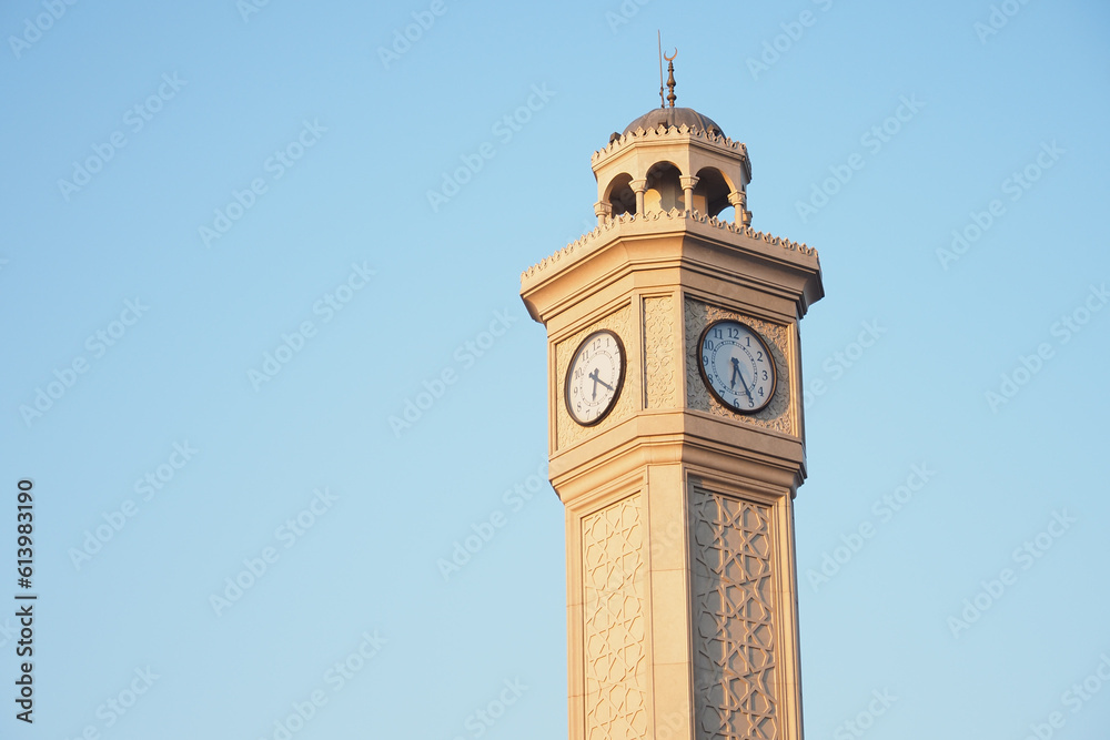 clock in a old tower against blue sky in turkey 