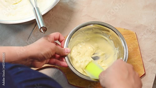 Top view pastry chef, confectioner heating callets of white confectionery Belgian chocolate on a water bath. Melting chocolate for making glaze or adding in whipped cream while making sweet dessert photo