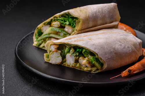 Delicious fresh roll with shrimps, tomatoes, lettuce and cucumber in pita bread