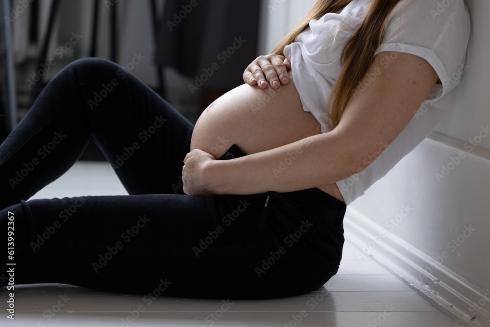 Close-up belly pregnant girl white top fingers hands folded heart stomach concept happy motherhood preparation for birth