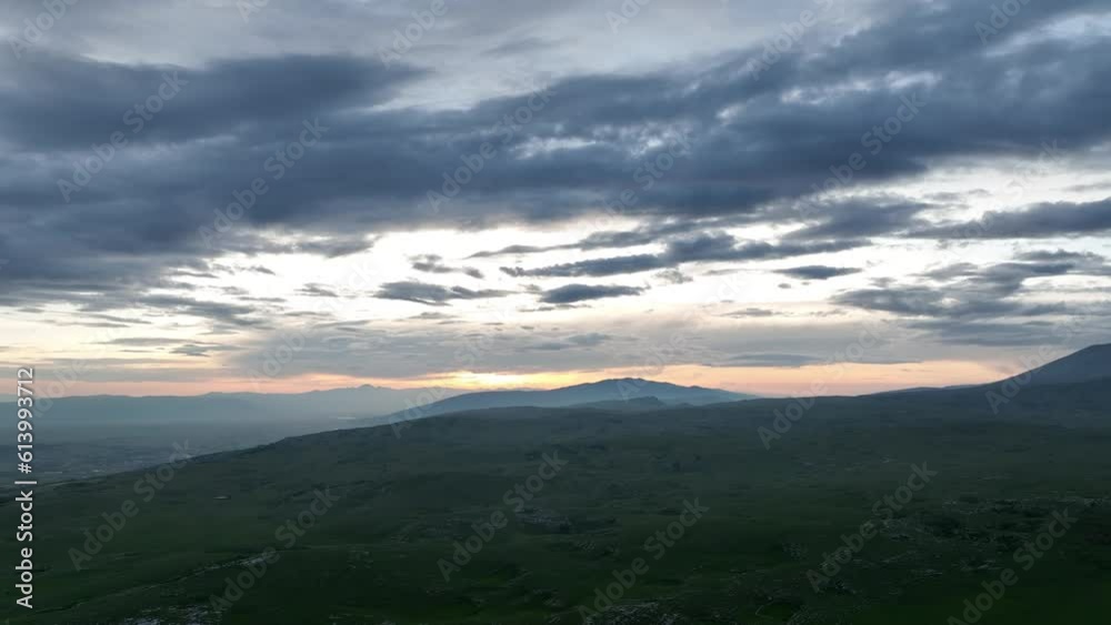 Aerial view of countryside landscape. Clouds with shades of purple, orange and green vegetation. Dramatic sky. Aerial view of countryside landscape. Clouds with shades of purple, orange and green vegetation. Dramatic sky.