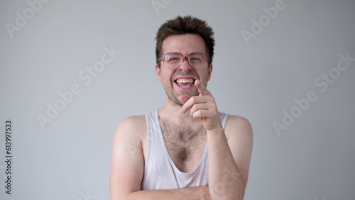 Valokuva A sarcastic man in big glasses mockingly laughs and points his finger at the cam