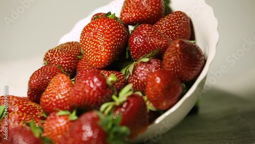 Bowl with ripe juicy strawberries on a linen napkin, pan, close-up