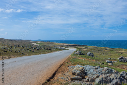 Beautiful view of stone desert of National Park with asphalt road against backdrop of Caribbean sea. photo