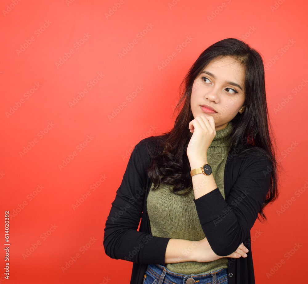 Hand on chin and doing thinking gesture Of Beautiful Asian Woman Isolated On Red Background Hand on chin and doing thinking gesture Of Beautiful Asian Woman Isolated On Red Background