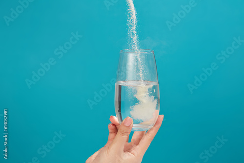Vászonkép Powdered medicine being poured from above into a glass of water