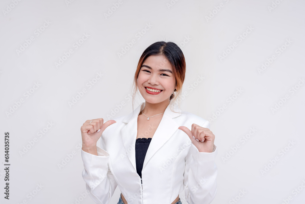 A smiling and happy young lady pointing to herself while looking at the camera. Isolated on a white background. A smiling and happy young lady pointing to herself while looking at the camera. Isolated on a white background.