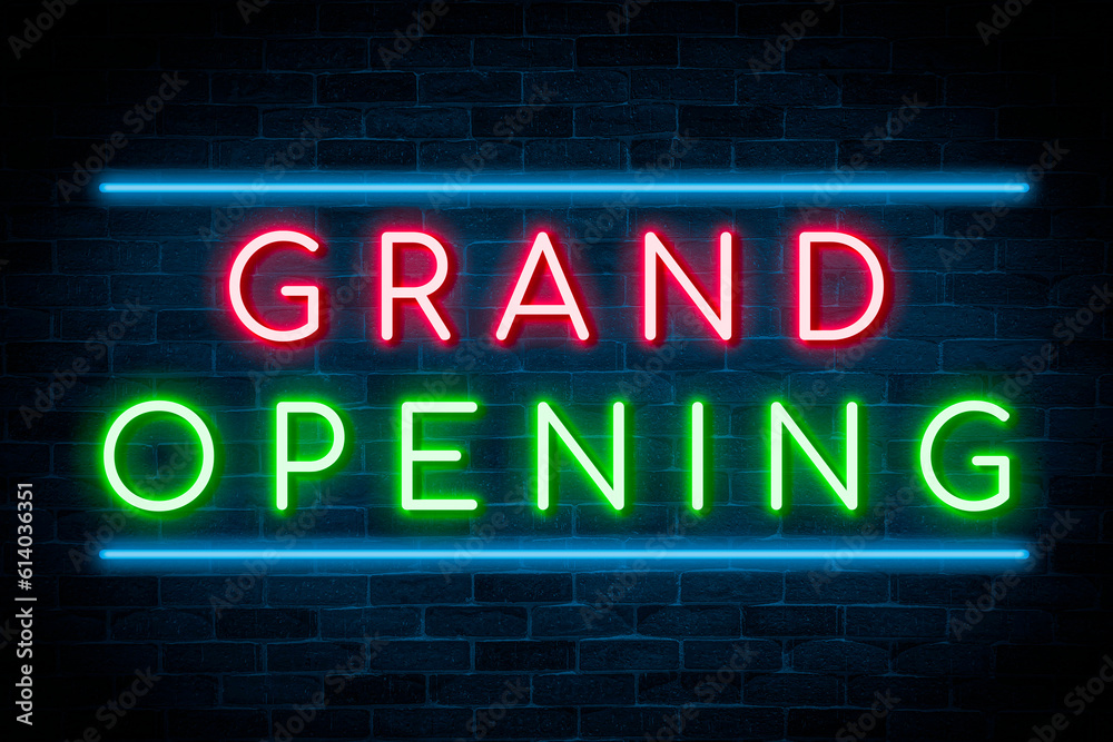 Grand Opening neon on brick wall background.