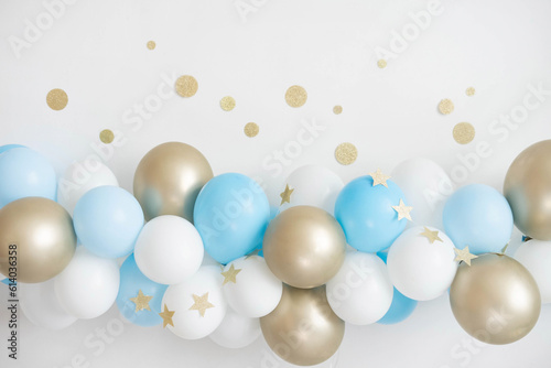 Garland of white, blue and gold balloons. Decor for baby shower.