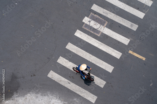 Lonely woman wear ride bicycle on street of Asian city