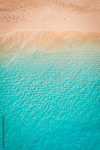 Relaxing aerial beach landscape, summer vacation holiday Mediterranean. Waves surf with amazing blue ocean lagoon, sea shore, coastline. Tranquil aerial drone top view. Peaceful bright beach, seaside