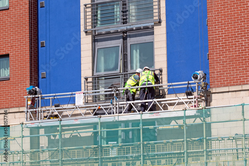 Workmen on a suspended platform