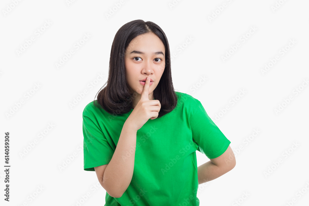 Young Asian woman asking to be silence and quiet gesturing with finger on lips Young Asian woman asking to be silence and quiet gesturing with finger on lips