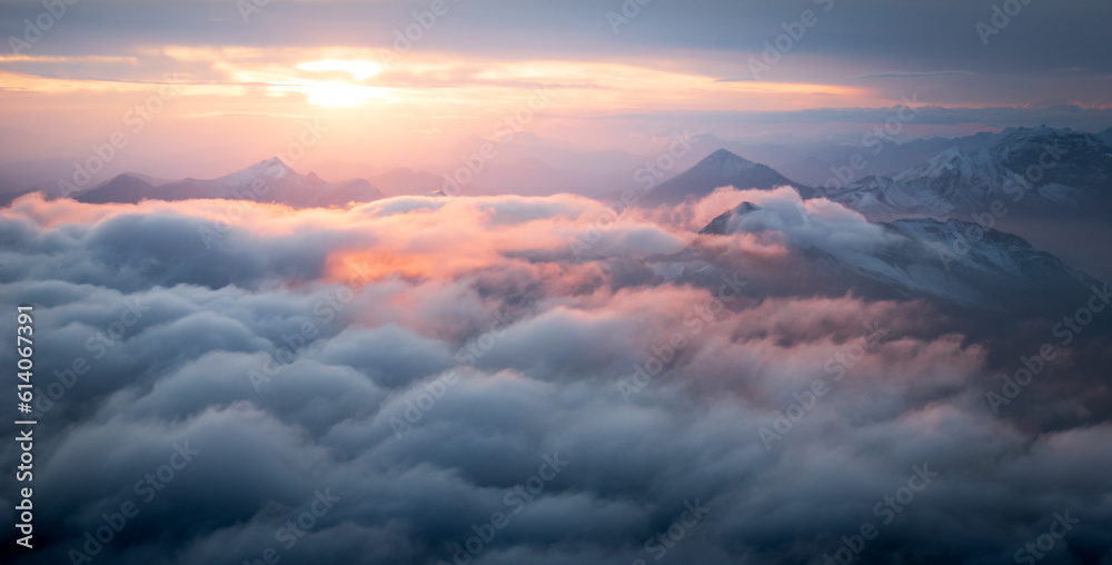 Colorful sunrise above alpine landscape with clouds and snowy mountains, Austrian Alps, Europe Colorful sunrise above alpine landscape with clouds and snowy mountains, Austrian Alps, Europe