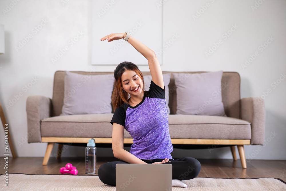 Asian women is stretching befor exercises at home. home exercise concept. Asian women is stretching befor exercises at home. home exercise concept.