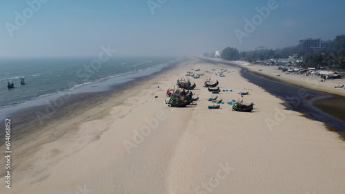 Drone shot of lined up traditional bangladeshi wooden handcrafted fishing boats called Sampan at Cox's Bazar sea beach photo
