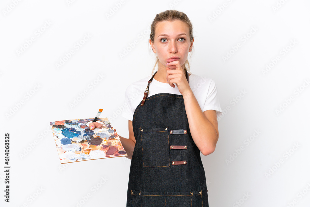 Young artist caucasian woman holding a palette isolated on white background thinking Young artist caucasian woman holding a palette isolated on white background thinking