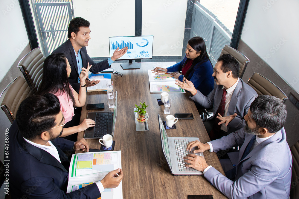 Φωτογραφία Indian business people meeting presentation in office conference room showing Charts Infographics on TV screen to show growth of company and big data analysis