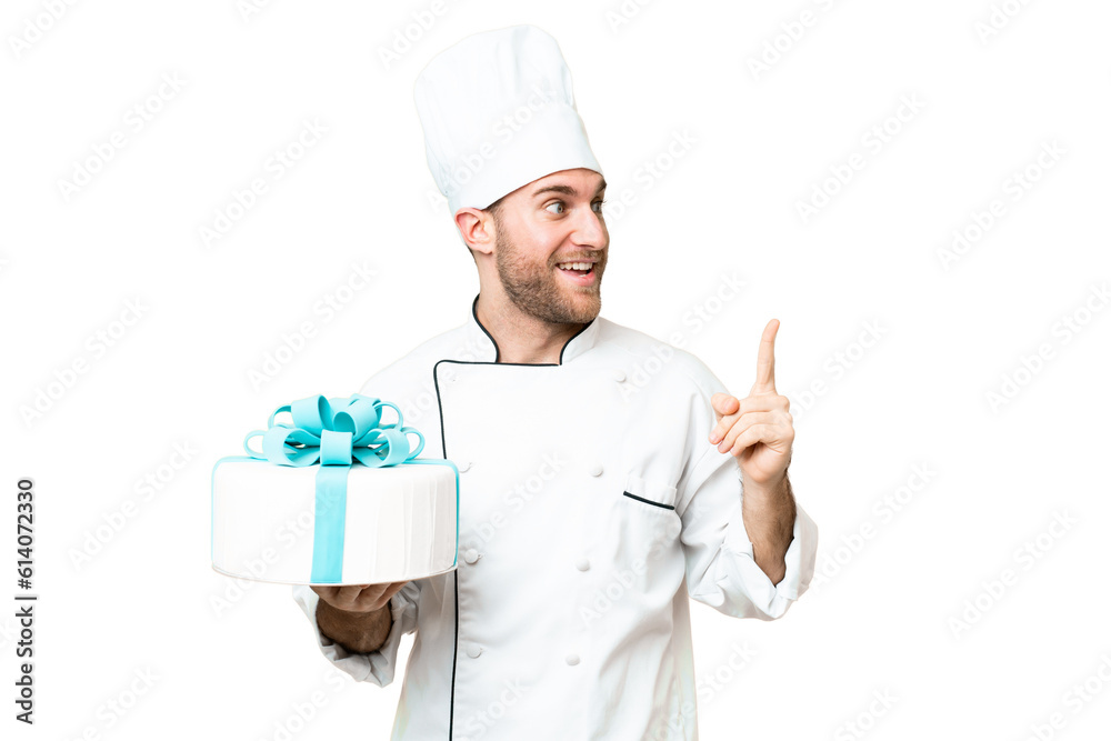 Young handsome blonde man with a big cake over isolated chroma key background intending to realizes the solution while lifting a finger up Young handsome blonde man with a big cake over isolated chroma key background intending to realizes the solution while lifting a finger up