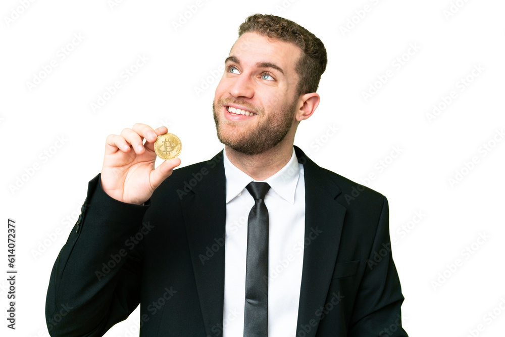 Young business blonde man holding a Bitcoin over isolated chroma key background thinking an idea while looking up Young business blonde man holding a Bitcoin over isolated chroma key background thinking an idea while looking up