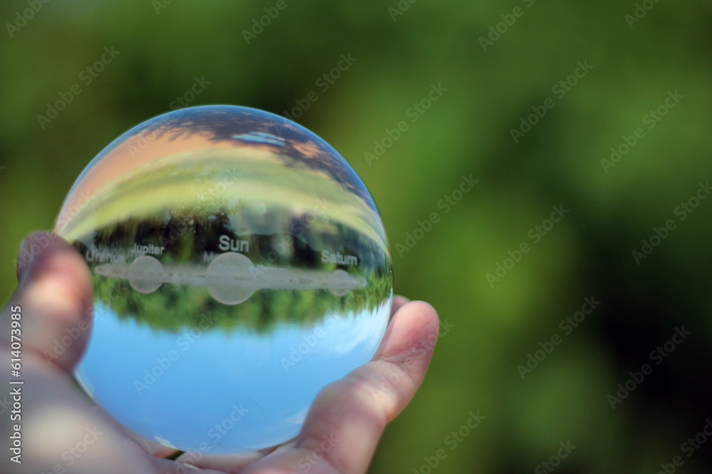 Nature photography of crystal ball with solar system in it, space, future environment and ESG concept