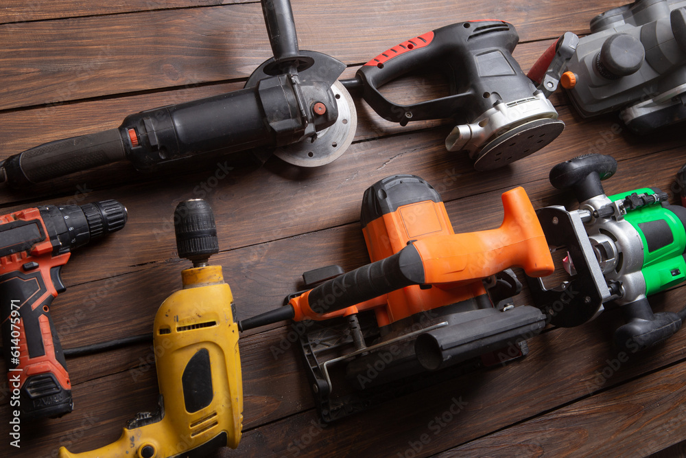 Set of electric tools on the wooden table. Various power tools for renovation and construction