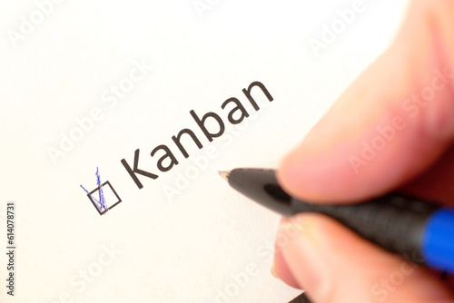 Hand daw in the questionnaire. A closeup of female hand answering about using kanban methodology in software development process question marking in a checkbox