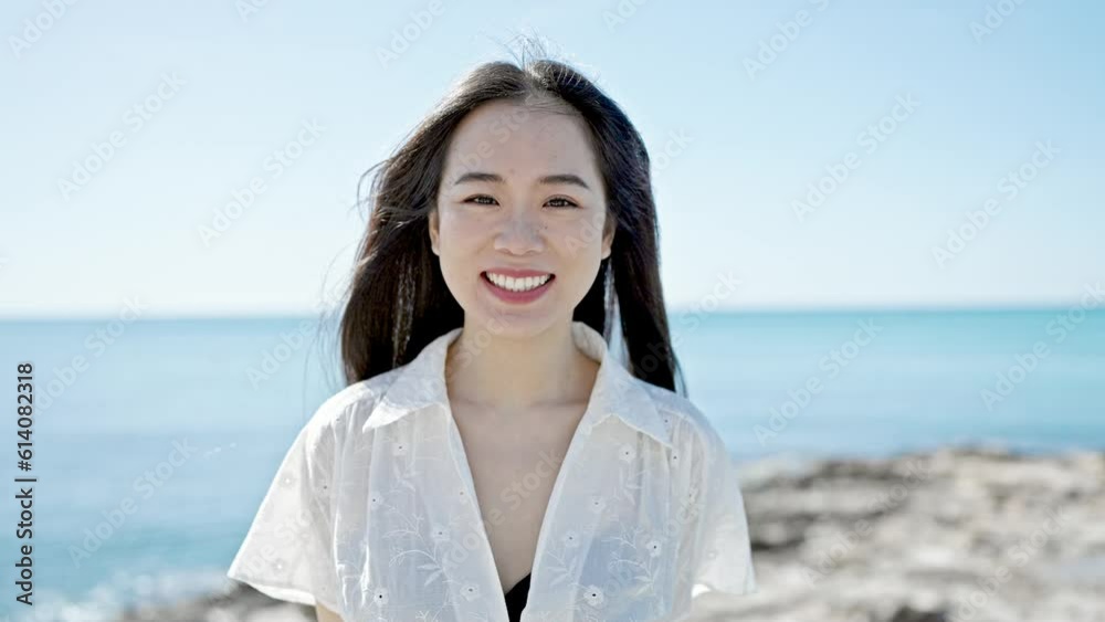 Young chinese woman smiling confident kissing at seaside Young chinese woman smiling confident kissing at seaside
