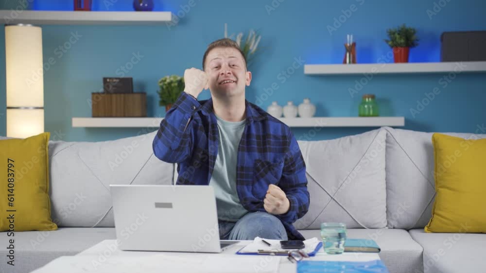 Home office worker man experiencing joy looking at camera. Home office worker man experiencing joy looking at camera.