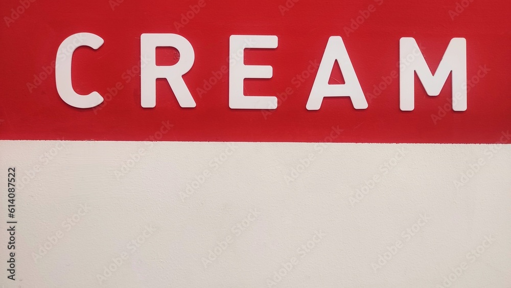 cream word stick on the white and red wall of cafe as decoration