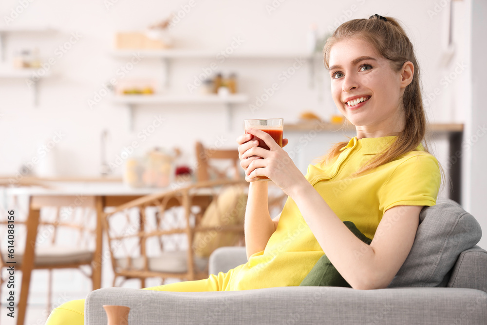 Sporty young woman with glass of vegetable juice in kitchen Sporty young woman with glass of vegetable juice in kitchen